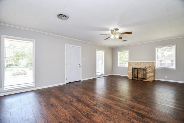 1225 Kirsten St, Galveston, TX 77568 - unfurnished living room with crown molding, a ceiling fan, a brick fireplace, dark wood-type flooring, and baseboards