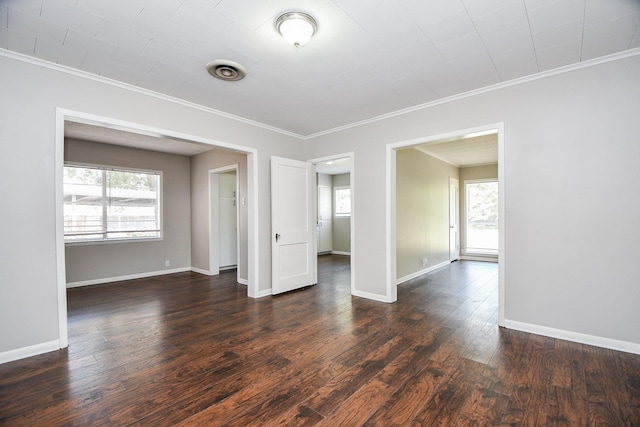 1225 Kirsten St, Galveston, TX 77568 - unfurnished room featuring ornamental molding, plenty of natural light, dark wood-style flooring, and baseboards
