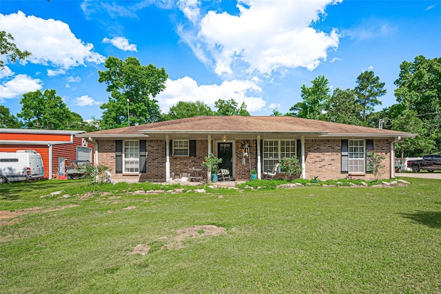 30926 Hilltop Ln, Magnolia, TX 77354 - ranch-style home featuring a front yard, brick siding, and a porch