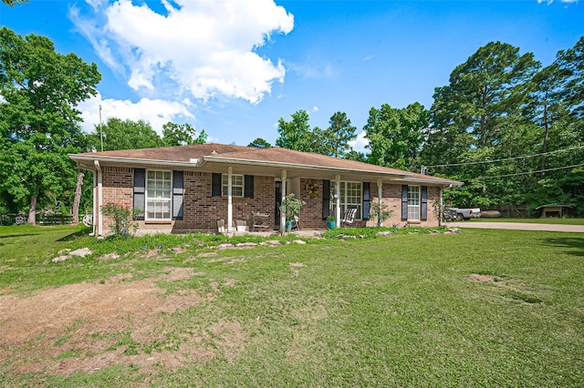 30926 Hilltop Ln, Magnolia, TX 77354 - single story home featuring a front lawn, brick siding, and covered porch