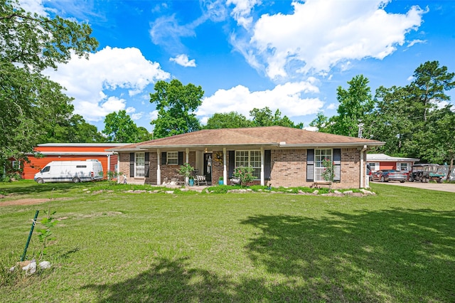 30926 Hilltop Ln, Magnolia, TX 77354 - single story home with a front yard, brick siding, and covered porch