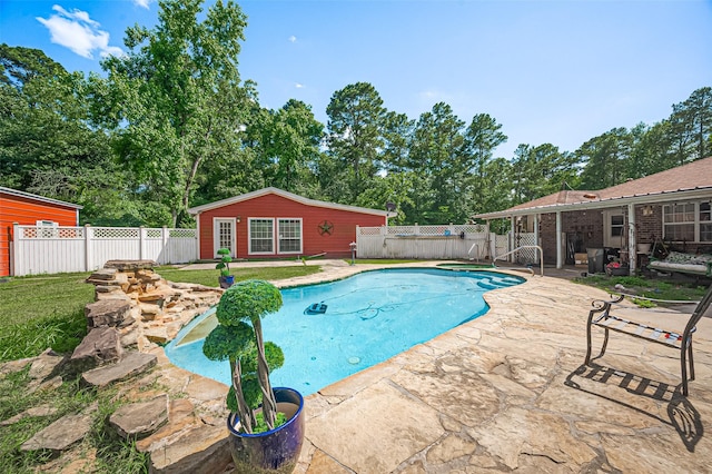 30926 Hilltop Ln, Magnolia, TX 77354 - view of swimming pool featuring a patio, an outdoor structure, and view of wooded area