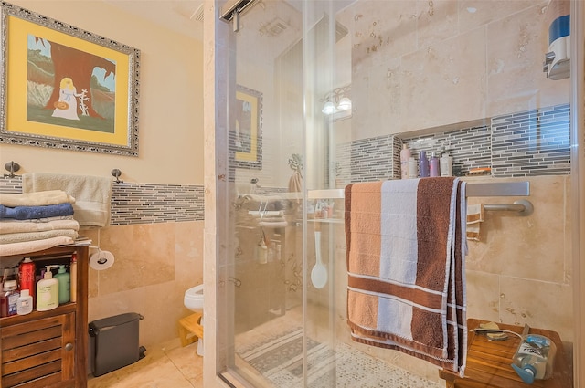 30926 Hilltop Ln, Magnolia, TX 77354 - bathroom with tile walls, a shower stall, toilet, and tile patterned flooring