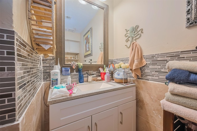30926 Hilltop Ln, Magnolia, TX 77354 - bathroom with tile walls, vanity, and a wainscoted wall