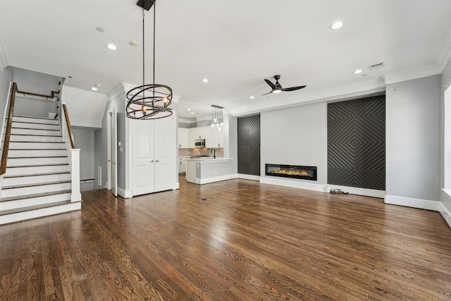 3302 Audley St Unit 110, Houston, TX 77098 - unfurnished living room featuring ceiling fan, crown molding, recessed lighting, baseboards, and stairway