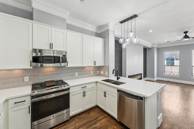 3302 Audley St Unit 110, Houston, TX 77098 - kitchen with appliances with stainless steel finishes, a sink, crown molding, ceiling fan, and a large fireplace