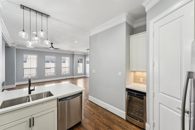 3302 Audley St Unit 110, Houston, TX 77098 - kitchen featuring beverage cooler, dishwasher, a sink, ornamental molding, and baseboards