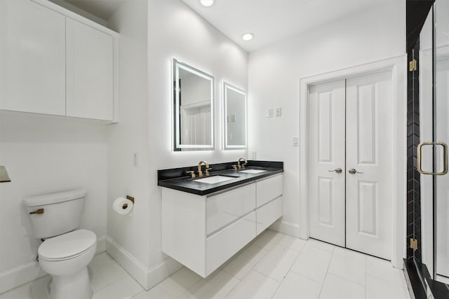 3302 Audley St Unit 110, Houston, TX 77098 - bathroom with baseboards, toilet, double vanity, recessed lighting, and tile patterned flooring