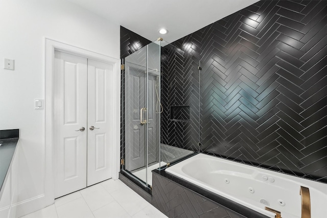 3302 Audley St Unit 110, Houston, TX 77098 - bathroom with a tub with jets, a stall shower, and tile patterned floors