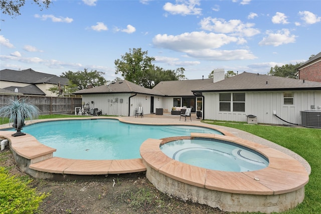 view of swimming pool with central AC unit, a patio, a pool with connected hot tub, and an outdoor living space