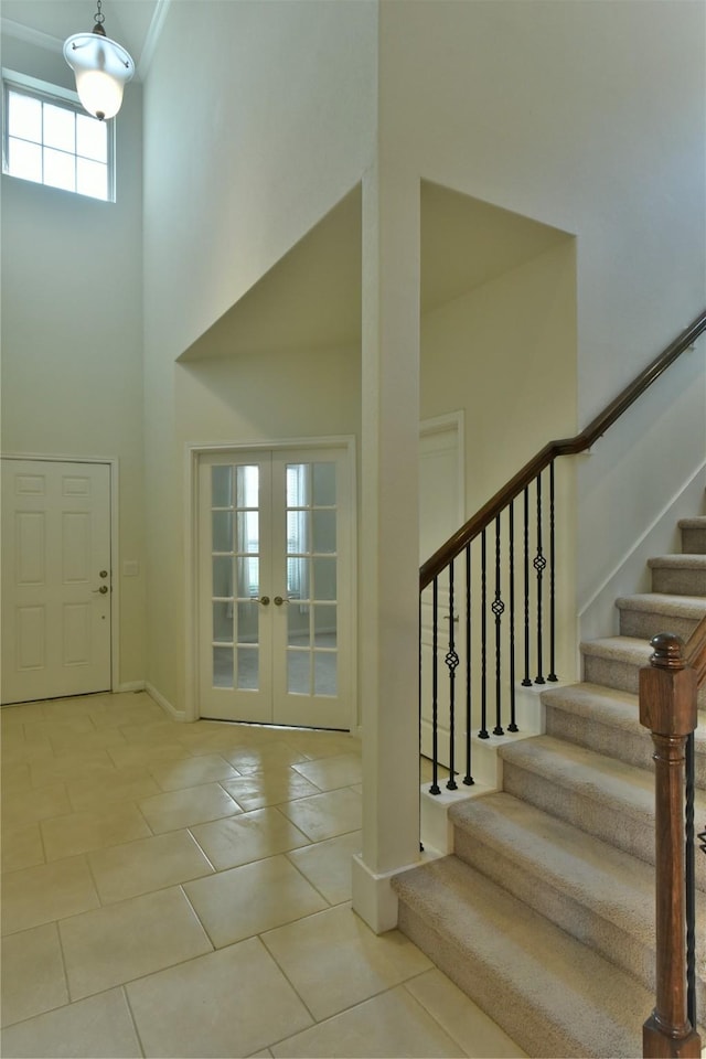 5118 Kingship Ct, Katy, TX 77493 - tiled entrance foyer with a high ceiling, stairway, french doors, and baseboards