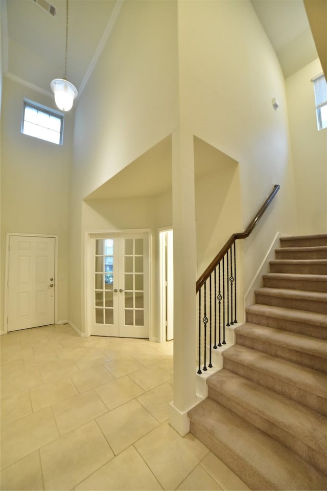 5118 Kingship Ct, Katy, TX 77493 - foyer entrance featuring a towering ceiling, stairs, french doors, baseboards, and ornamental molding