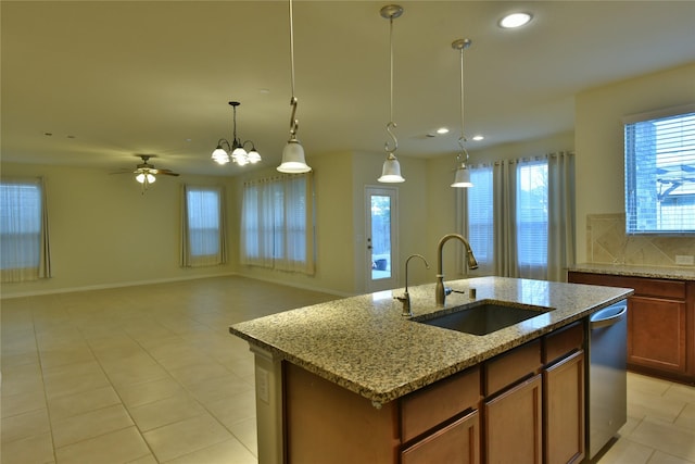 5118 Kingship Ct, Katy, TX 77493 - kitchen with a sink, dishwasher, light tile patterned floors, a center island with sink, and recessed lighting