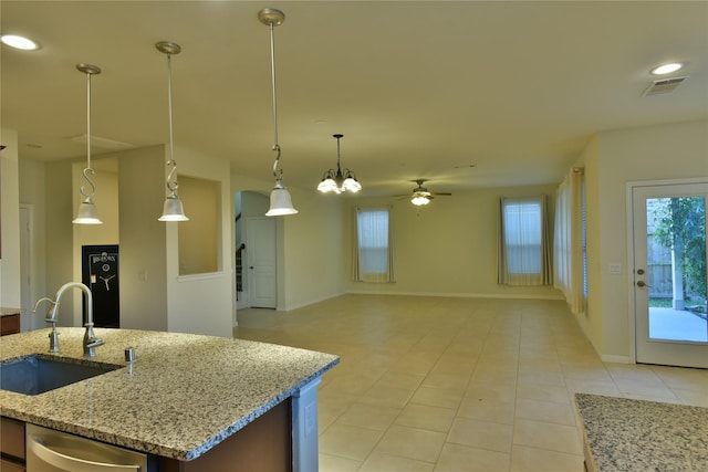5118 Kingship Ct, Katy, TX 77493 - kitchen with a sink, light tile patterned flooring, a ceiling fan, baseboards, and open floor plan