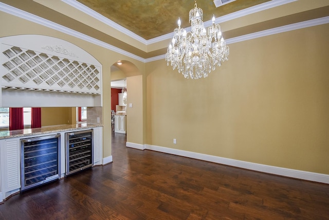 5450 Pudman River Ln, Sugar Land, TX 77479 - indoor dry bar featuring beverage cooler, dark wood-style floors, arched walkways, baseboards, and crown molding