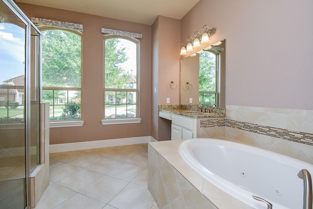5450 Pudman River Ln, Sugar Land, TX 77479 - bathroom with vanity, plenty of natural light, a jetted tub, and tile patterned floors