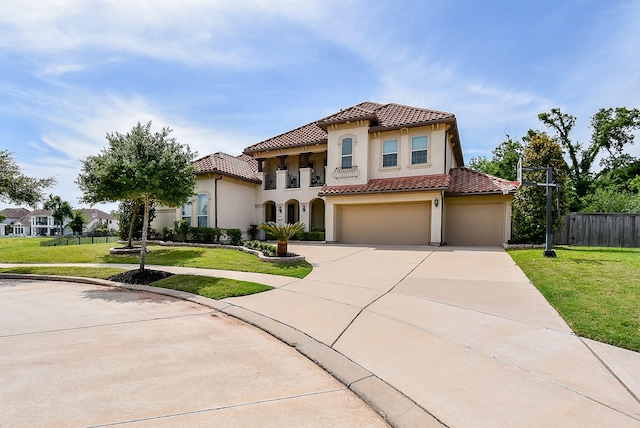 5450 Pudman River Ln, Sugar Land, TX 77479 - mediterranean / spanish-style home featuring a tiled roof, concrete driveway, stucco siding, and an attached garage