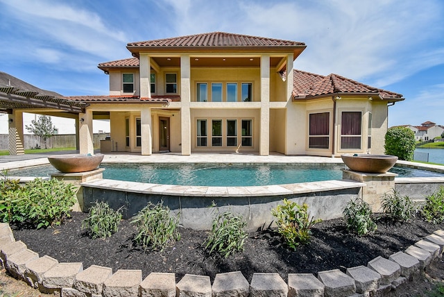 5450 Pudman River Ln, Sugar Land, TX 77479 - rear view of house with a tiled roof, an infinity pool, and stucco siding