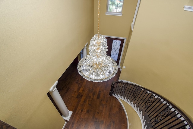 5450 Pudman River Ln, Sugar Land, TX 77479 - stairway with wood finished floors, a chandelier, and a towering ceiling