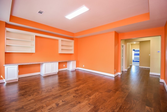 5450 Pudman River Ln, Sugar Land, TX 77479 - spare room with baseboards, dark wood-style floors, built in shelves, and a raised ceiling