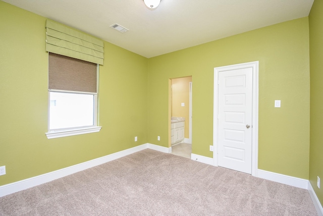 5450 Pudman River Ln, Sugar Land, TX 77479 - unfurnished bedroom with light colored carpet, baseboards, and ensuite bath
