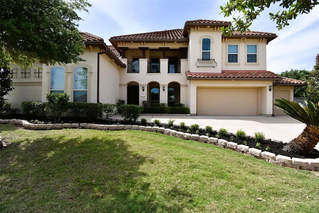 5450 Pudman River Ln, Sugar Land, TX 77479 - mediterranean / spanish-style home with stucco siding, concrete driveway, an attached garage, a balcony, and a tile roof