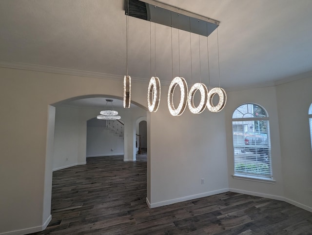 4202 Blue Sage Ter, Spring, TX 77388 - unfurnished dining area featuring arched walkways, dark wood-style flooring, ornamental molding, baseboards, and a chandelier