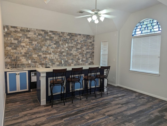 4202 Blue Sage Ter, Spring, TX 77388 - dining space featuring bar with sink, dark wood finished floors, a ceiling fan, vaulted ceiling, and baseboards