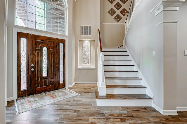 22015 Hanneck Ct, Katy, TX 77450 - foyer with a towering ceiling, baseboards, stairway, and wood finished floors