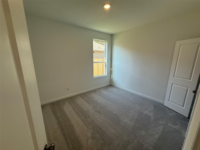 503 Shoreview Dr, Conroe, TX 77303 - spare room with dark carpet and baseboards