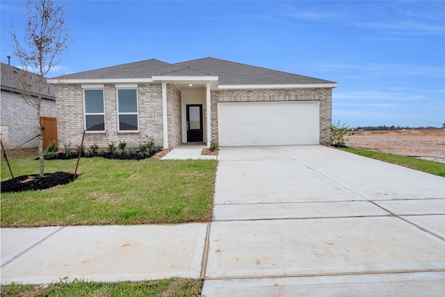 503 Shoreview Dr, Conroe, TX 77303 - prairie-style house with an attached garage, a front lawn, and concrete driveway