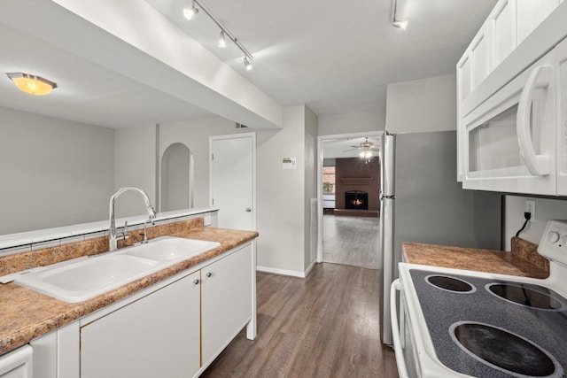 7736 Challie Ln, Houston, TX 77088 - kitchen with white appliances, a sink, dark wood-style flooring, white cabinetry, and light countertops