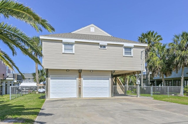4606 Jamaica Cove Rd, Jamaica Beach, TX 77554 - view of front of home with an attached garage, driveway, and a carport