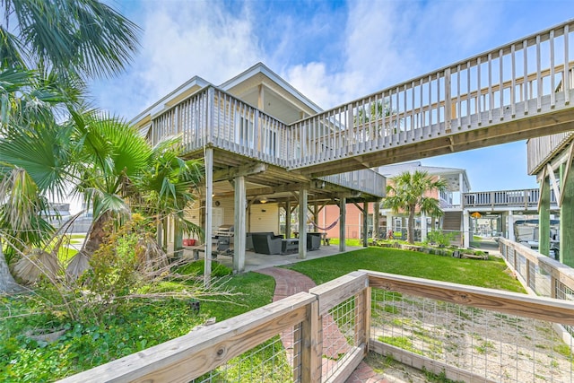 4606 Jamaica Cove Rd, Jamaica Beach, TX 77554 - rear view of house featuring a deck, a patio area, outdoor lounge area, and a lawn