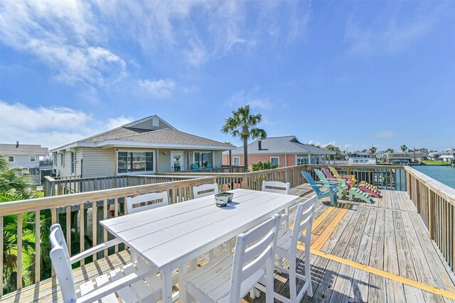 4606 Jamaica Cove Rd, Jamaica Beach, TX 77554 - wooden deck with outdoor dining space and a water view