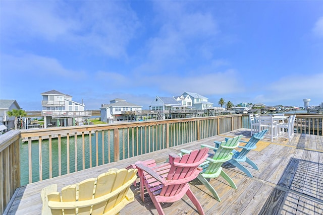 4606 Jamaica Cove Rd, Jamaica Beach, TX 77554 - wooden terrace with a water view, outdoor dining space, and a residential view