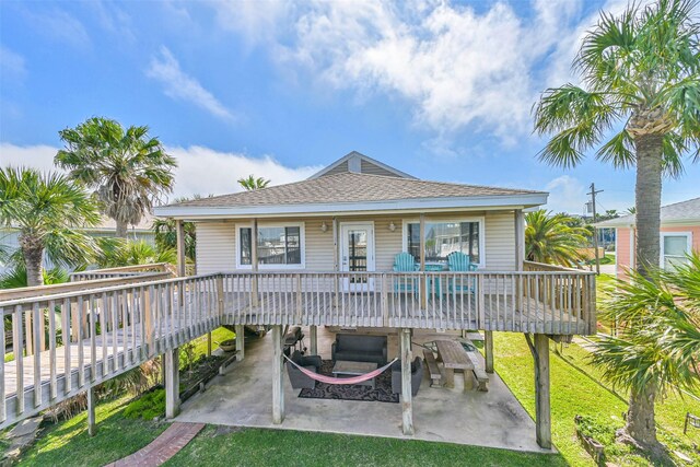 4606 Jamaica Cove Rd, Jamaica Beach, TX 77554 - back of property featuring a lawn, a patio, and a deck