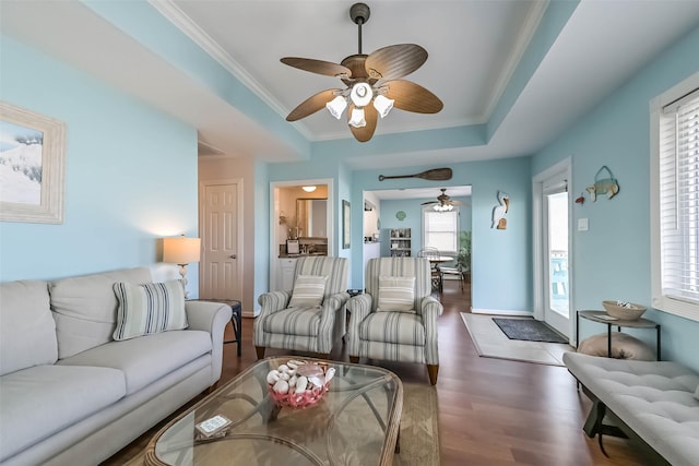 4606 Jamaica Cove Rd, Jamaica Beach, TX 77554 - living room with ceiling fan, ornamental molding, wood finished floors, baseboards, and a raised ceiling