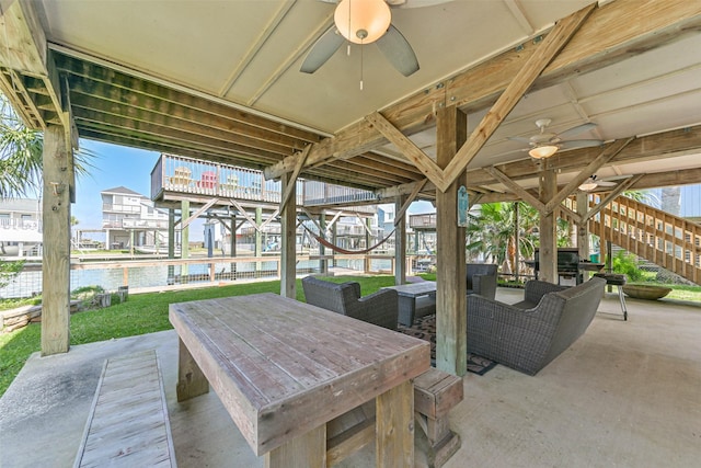 4606 Jamaica Cove Rd, Jamaica Beach, TX 77554 - view of patio with a ceiling fan, stairway, a water view, outdoor lounge area, and outdoor dining space