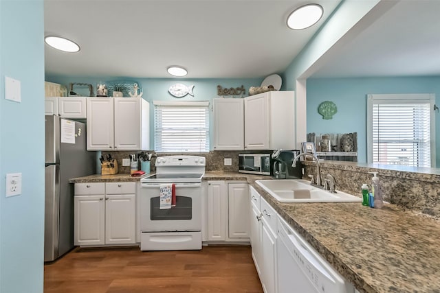 4606 Jamaica Cove Rd, Jamaica Beach, TX 77554 - kitchen with appliances with stainless steel finishes, a sink, white cabinetry, and tasteful backsplash