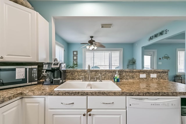 4606 Jamaica Cove Rd, Jamaica Beach, TX 77554 - kitchen featuring dishwasher, stainless steel microwave, ceiling fan, a sink, and white cabinetry