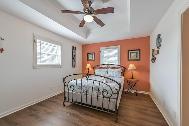 4606 Jamaica Cove Rd, Jamaica Beach, TX 77554 - bedroom featuring a raised ceiling, wood finished floors, baseboards, and ceiling fan