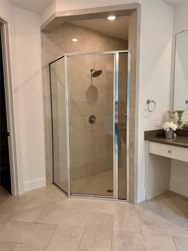 1215 Tallow Park Ln, Pinehurst, TX 77362 - bathroom featuring a stall shower, vanity, and baseboards