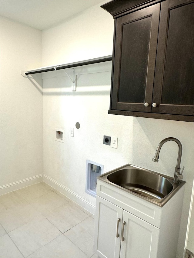 1215 Tallow Park Ln, Pinehurst, TX 77362 - laundry area with hookup for an electric dryer, cabinet space, washer hookup, baseboards, and light tile patterned floors