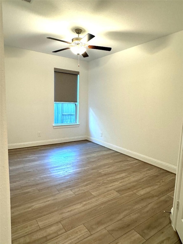 1215 Tallow Park Ln, Pinehurst, TX 77362 - unfurnished room featuring wood finished floors, a ceiling fan, and baseboards