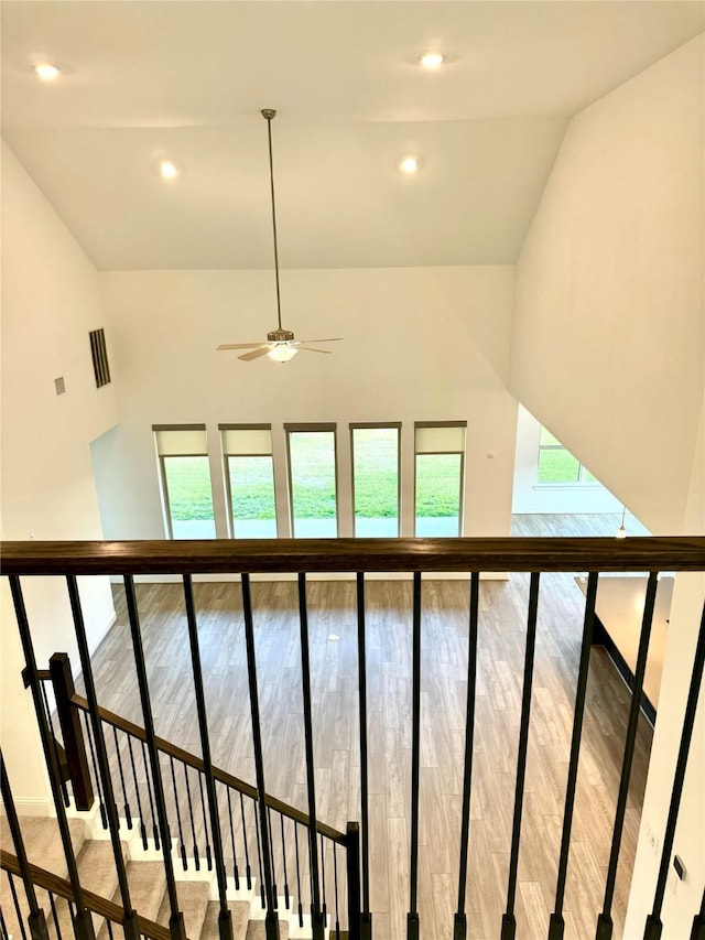 1215 Tallow Park Ln, Pinehurst, TX 77362 - staircase featuring plenty of natural light, ceiling fan, wood finished floors, vaulted ceiling, and recessed lighting