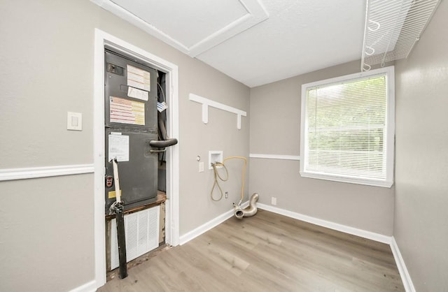 720 Roosevelt St, La Marque, TX 77568 - laundry area with washer hookup, wood finished floors, and baseboards