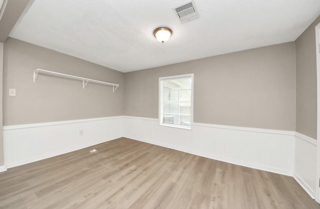 720 Roosevelt St, La Marque, TX 77568 - empty room featuring a wainscoted wall and wood finished floors