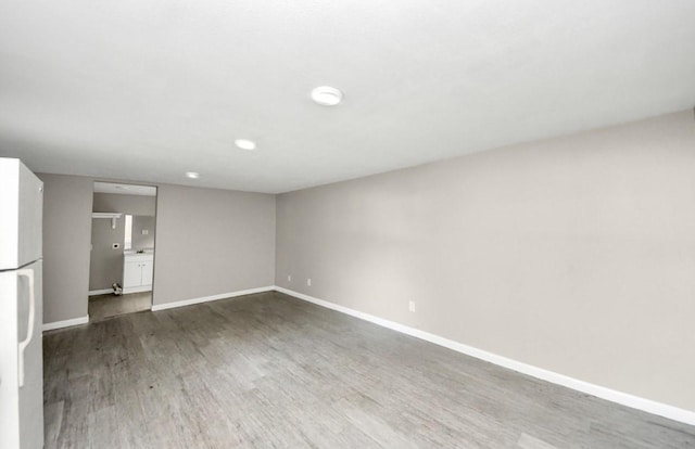 720 Roosevelt St, La Marque, TX 77568 - unfurnished living room with baseboards and dark wood finished floors
