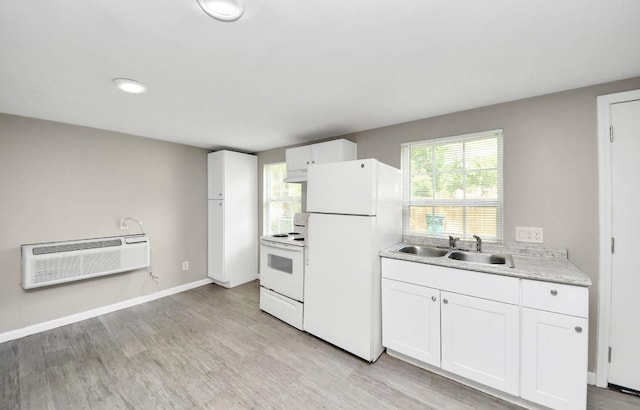 720 Roosevelt St, La Marque, TX 77568 - kitchen featuring a sink, white appliances, an AC wall unit, light countertops, and light wood-style floors